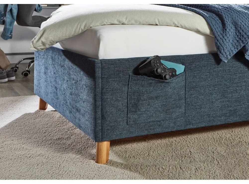 Тъмносиньо тапицирано детско легло 140x200 cm с място за съхранение с включена подматрачна рамка Fun – Meise Möbel